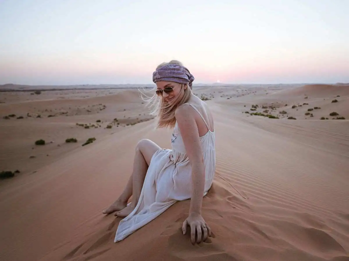 Guest enjoying the sunset during an Evening Desert Safari Ab